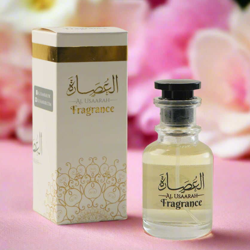Perfume bottle and packaging with gold and white design on a light gray background