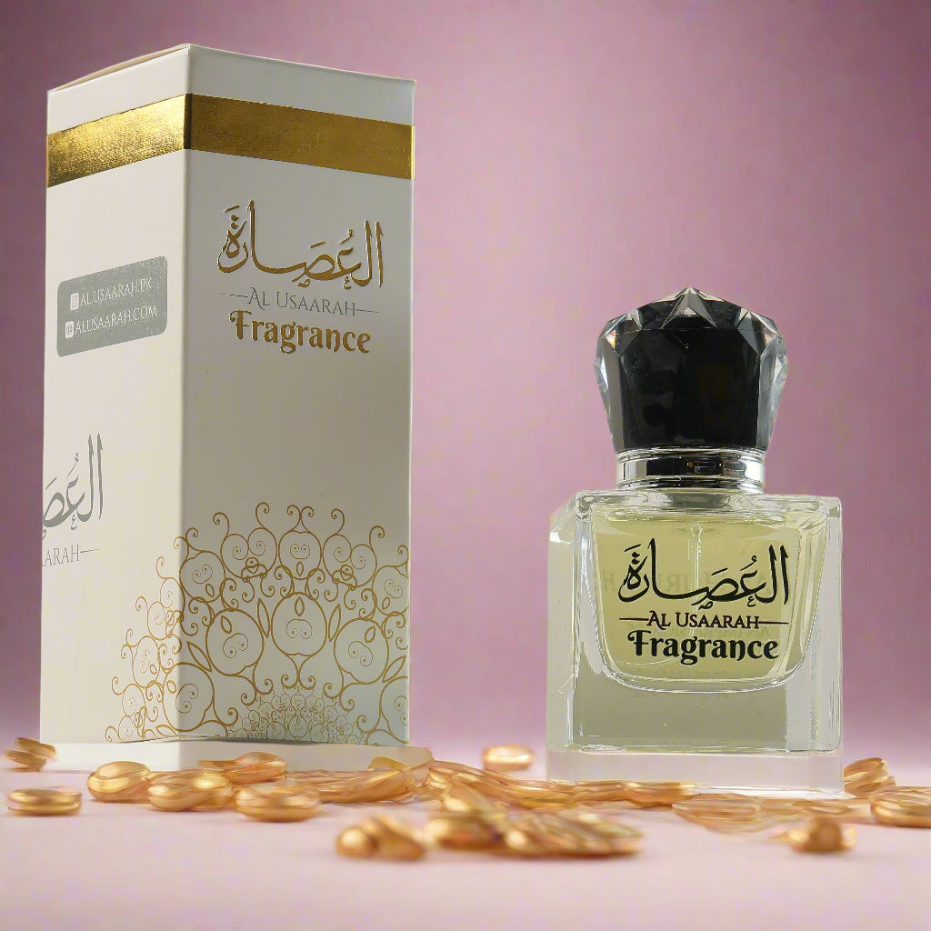 Perfume bottle and packaging with 'Al Usaarah' branding on a light pink background